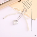 Silver plated bow keychain with white pearls and a heart pendant in a 11cm length - White Pearl Bow Heart Charm
