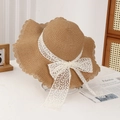 Women's light brown straw sun hat with elegant white lace bow and wavy brim - Lace Water Grass Khaki