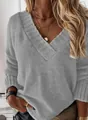 Close-up of gray V-neck knit sweater showing thick ribbed texture and casual long sleeves - Gray