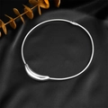 Minimalist silver moon pendant on a sleek snake chain displayed on black silk fabric - Crescent Pendant Snake Chain (N2515) / Steel Color (N2515)