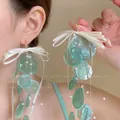 Mint green shell tassel drop earrings with white ribbon bow for a summer beach look - Green Bow Shell (3# Ear Hook)