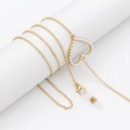 Elegant gold eyewear chain featuring an openwork heart pendant with white pearls - Heart Charm with Pearls