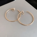 Detailed view of gold round clip-on earrings with protective silicone pads for comfort - 5cm / Gold / Clip-On Earrings