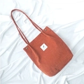 Orange corduroy tote bag for women featuring a minimalist design and white fabric patch - Brick Red