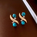 Detailed close-up of golden S-shaped earrings with blue turquoise beads and tiny rhinestones - Earrings (925 Sterling Silver Earring Post) / Gold