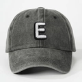 Close-up of vintage washed cotton fabric and 3D white letter E embroidery on dark gray cap - Letter E