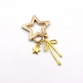 Golden metal star keychain with bow and star charms on a white background - Gold Star Pendant