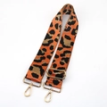 Close-up of leopard print bag strap with golden metal swivel hooks and adjustable buckle - Orange With Gold Buckle