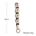 Handmade woven daisy flower keychain in black and white with gold metal ring 18cm long - Black White & Yellow