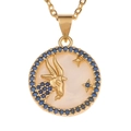 Macro shot of Capricorn necklace pendant with white mother of pearl and blue gemstones - Capricorn
