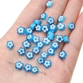 Blue and white glass flower beads for handmade jewelry on a white background - Blue & White