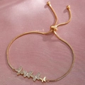 Adjustable golden butterfly bolo bracelet with shimmering micro-pave crystals on pink satin - Gold Four Butterflies