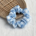 Chic blue and white plaid scrunchie hair tie on a decorative woven tray with linen background - Blue Plaid