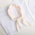 Solid light pink silk square scarf elegantly tied on a white t-shirt collar neckline - Pearl White