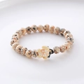 Detailed close-up of dalmatian jasper stone beads with a cute sea turtle pendant charm - Beige Brown Spotted Turtle Wood Bracelet