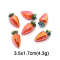 Macro shot of 3.5x1.7cm carrot charms with pearlescent finish and green leaf details - Iridescent Carrot