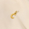Polished gold stainless steel letter C pendant charm on elegant beige silk background - Letter-C