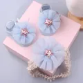 Detail of infant headband and socks set featuring light blue mesh flowers and pink sequins - Style 11 (Light Blue Pink Star/Pink Star)