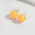 Minimalist round stud earrings featuring orange marble texture and gold metallic base - Yellow