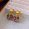 Detailed macro view of purple resin sphere earrings hanging on a gray velvet box - 27# Silver Needle-Gold-Red