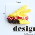 Macro detail of 5cm realistic resin bread basket fridge magnet on white card - Cheese Baguette Basket