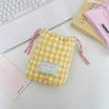Close-up of heart-quilted pattern and pink drawstring on yellow checkered camera bag - Yellow Plaid