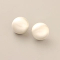 Detail view of round cream pearl stud earrings with a smooth brushed matte texture - Brushed Sphere Studs / Silver