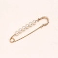 Golden waist pin with white pearls for clothing adjustment on a beige background - 7cm 6 Pearls Gold