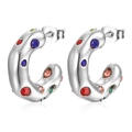 Macro view of C-shaped stainless steel earrings with colorful inlaid rhinestones - Silver/Multicolor Zirconia