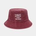 Macro detail of the 90th birthday embroidery on a washed cotton burgundy bucket hat - 90 Years Old Birthday Style / Burgundy