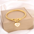 Gold-tone titanium steel bracelet with a heart pendant featuring an engraved letter V - Letter V