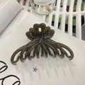 Detail shot of a large resin hair claw clip in translucent grey-brown with wave texture - Approx 11cm / Dark Gray