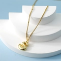 Golden 3D bubble letter S pendant necklace with beaded chain on a minimalist display - Letter S(S)