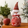 Knitted Santa Claus Christmas gift bag with drawstring on a cozy festive wooden table - Knitted Santa Bag