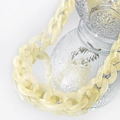 Close-up of a creamy yellow chunky acrylic resin chain wrapped around a glass bottle - Beige Cream Necklace