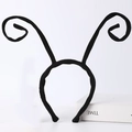 Detail view of black plush insect antenna headband for Halloween costumes on white background - Black Ant Antenna