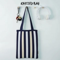 Vertical blue and white striped knitted tote bag with double handles in a cozy home setting - Black & White Stripes