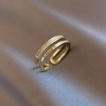 Macro shot of gold double-layer open ring with white enamel and Queen engraving - Gold Double Layer Queen Alphabet Style