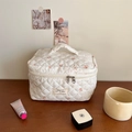 Quilted floral makeup bag in cream with dual zippers and portable handle design - White Red Floral