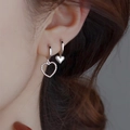 Detail of silver heart tassel earrings worn by a model in a trendy Korean retro style - Heart Hoop
