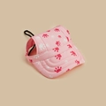 Detail of pink dog sun hat with red paw prints and adjustable chin strap and ear holes - Pink Heart Paw Print
