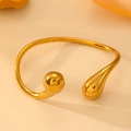 Polished gold stainless steel open bangle with teardrop and spherical ends on leather - Gold