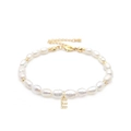 Close-up of natural freshwater pearl bracelet with a gold zircon-encrusted letter E charm - Letter E