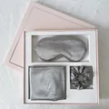 Detailed close-up of silver silk sleep set with eye mask and scrunchie in a pink gift box - Grey Gift Box Set (Eye Mask + Pillowcase + Scrunchie)