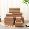 Stack of various sized brown kraft paper gift boxes with lids on a woven mat surface - No.1-2 Gift Bag 14.5*7*15cm / Kraft Paper Color