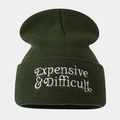 Close-up of white 'Expensive & Difficult' embroidery on dark green knit beanie - Army Green