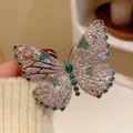 Eleganter Schmetterlingsbrosche in Silber mit hohlen Flügeln und grünen Zirkonia - Grün
