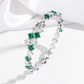 Detail showing square green and white zircon crystals on a silver stainless steel bangle - Emerald