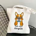 White canvas tote bag featuring a cartoon Corgi print with a blue polka dot bowtie - C8-Geek Corgi