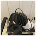 Detail of black semi-circular crossbody bag featuring luxury V-shaped chevron quilting - Black